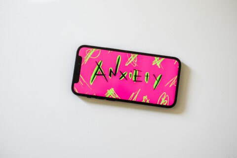 A phone case with anxiety written on it.